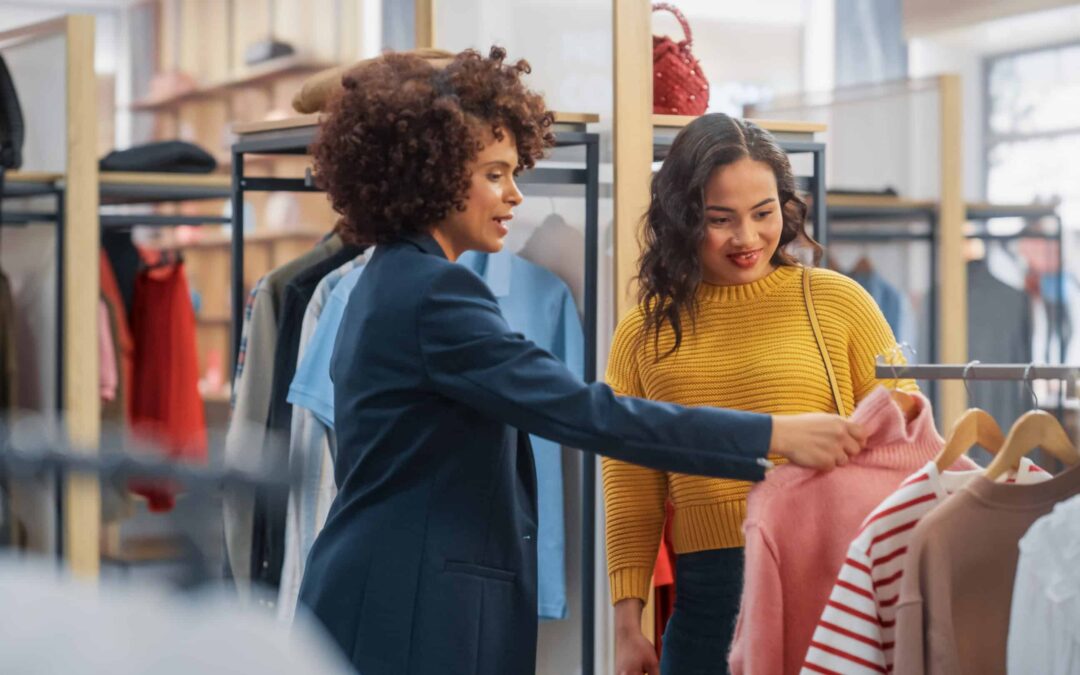 Young Female Customer Shopping in Clothing Store, Retail Sales Associate Helps with Advice. Diverse People in Fashionable Shop, Choosing Stylish Clothes, Colorful Brand with Sustainable Designs